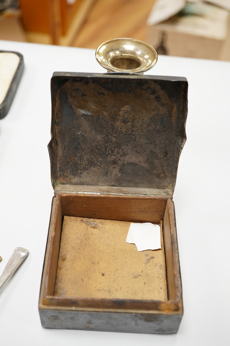 A collection of silver and white metal items, to include a cigarette box, a/f, a German dwarf candlestick, a cased spoon and pusher, etc.